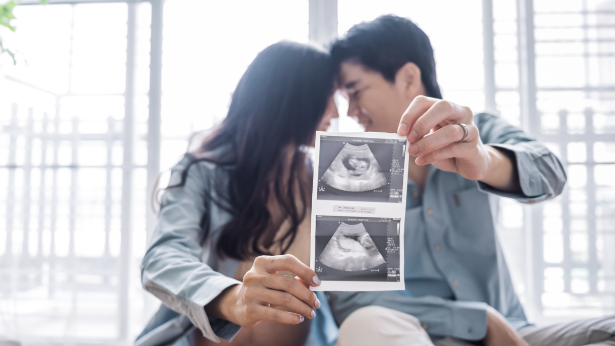 couple holding a sonogram