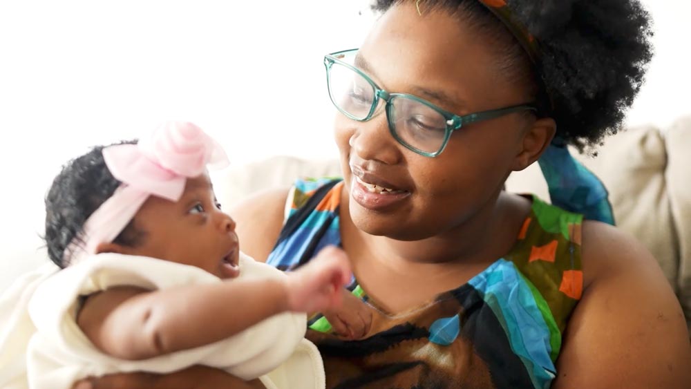 mom and baby girl looking and smiling at each other